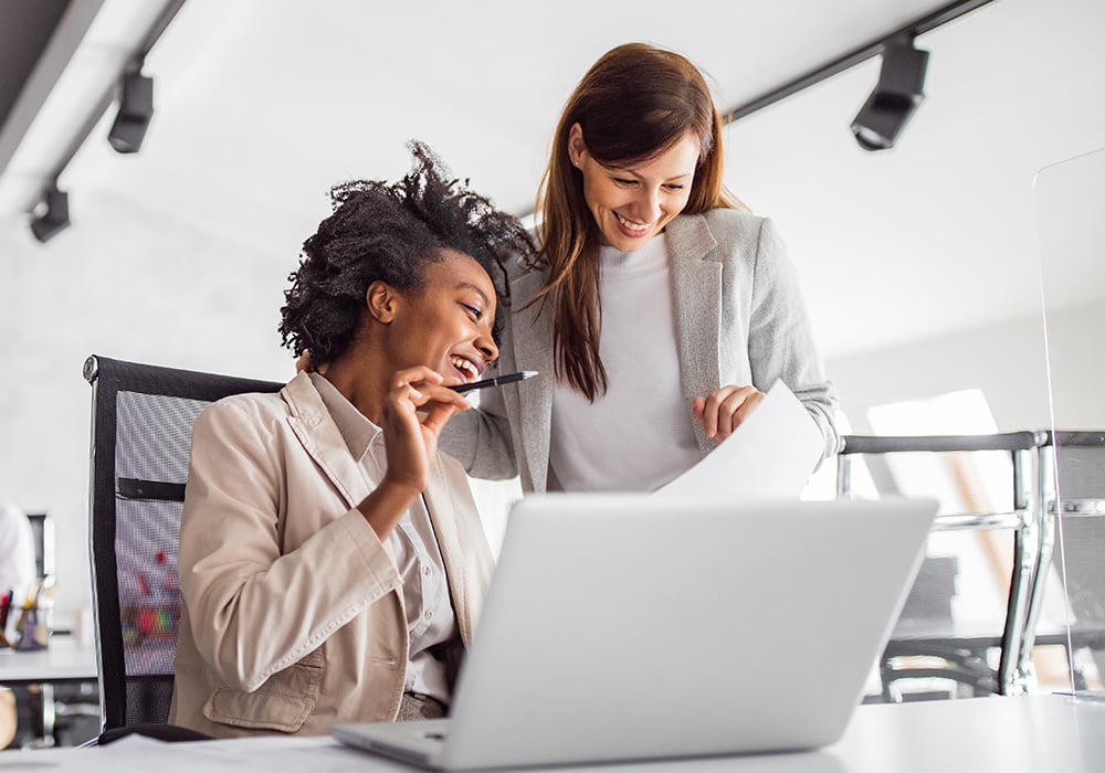 two employees discussing the new flock benefits administration service