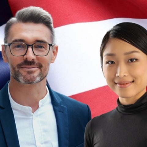 two citizens standing in front of the American flag