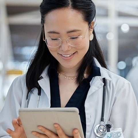 A doctor looking at a tablet
